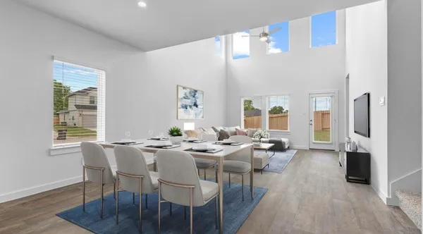 a dining room with furniture window and wooden floor