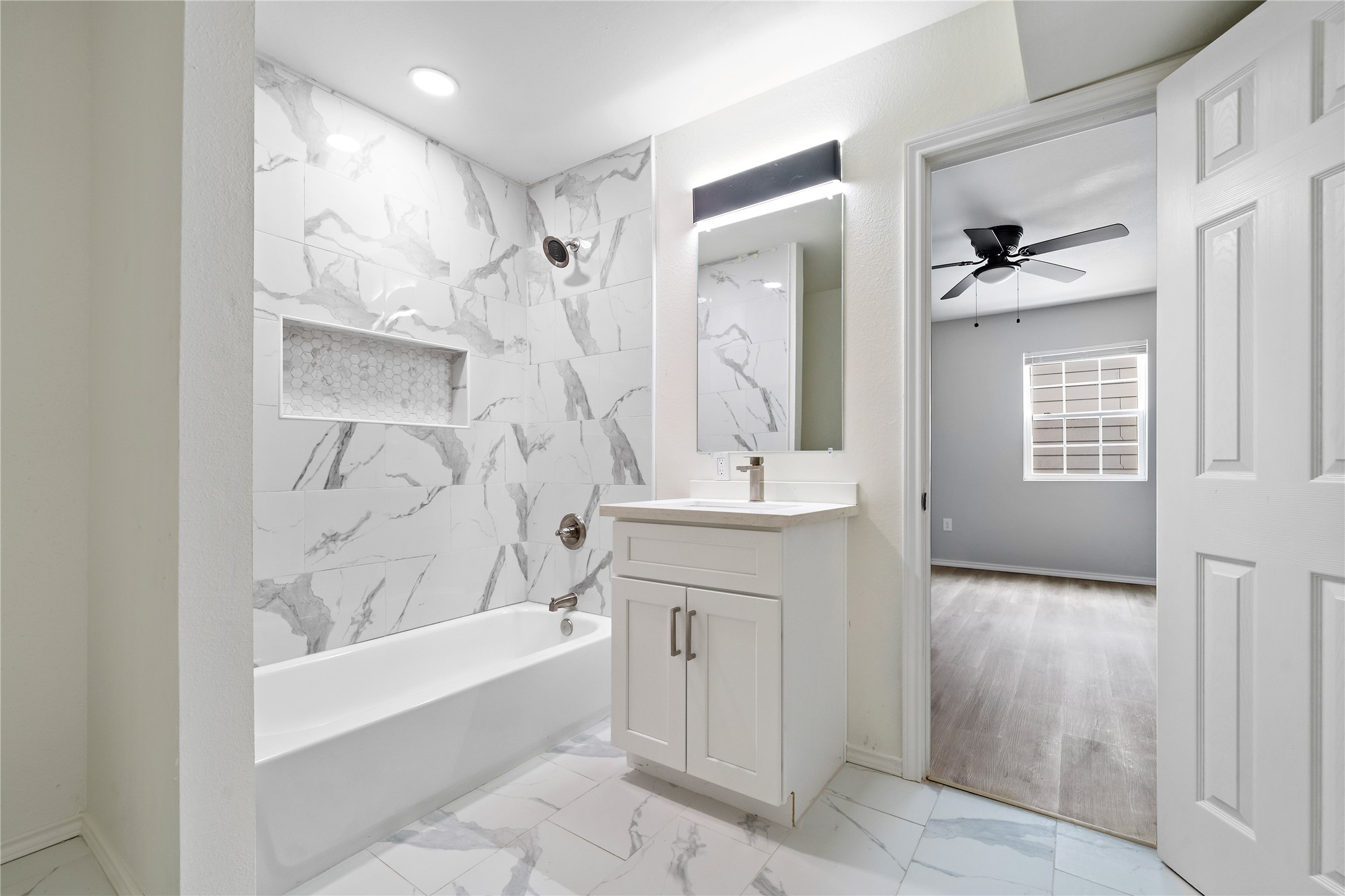 9711 Linkmeadow Lane, Unit 17 Houston, TX 77025 - Photo 3 of 15 a bathroom with a bathtub shower sink and mirror