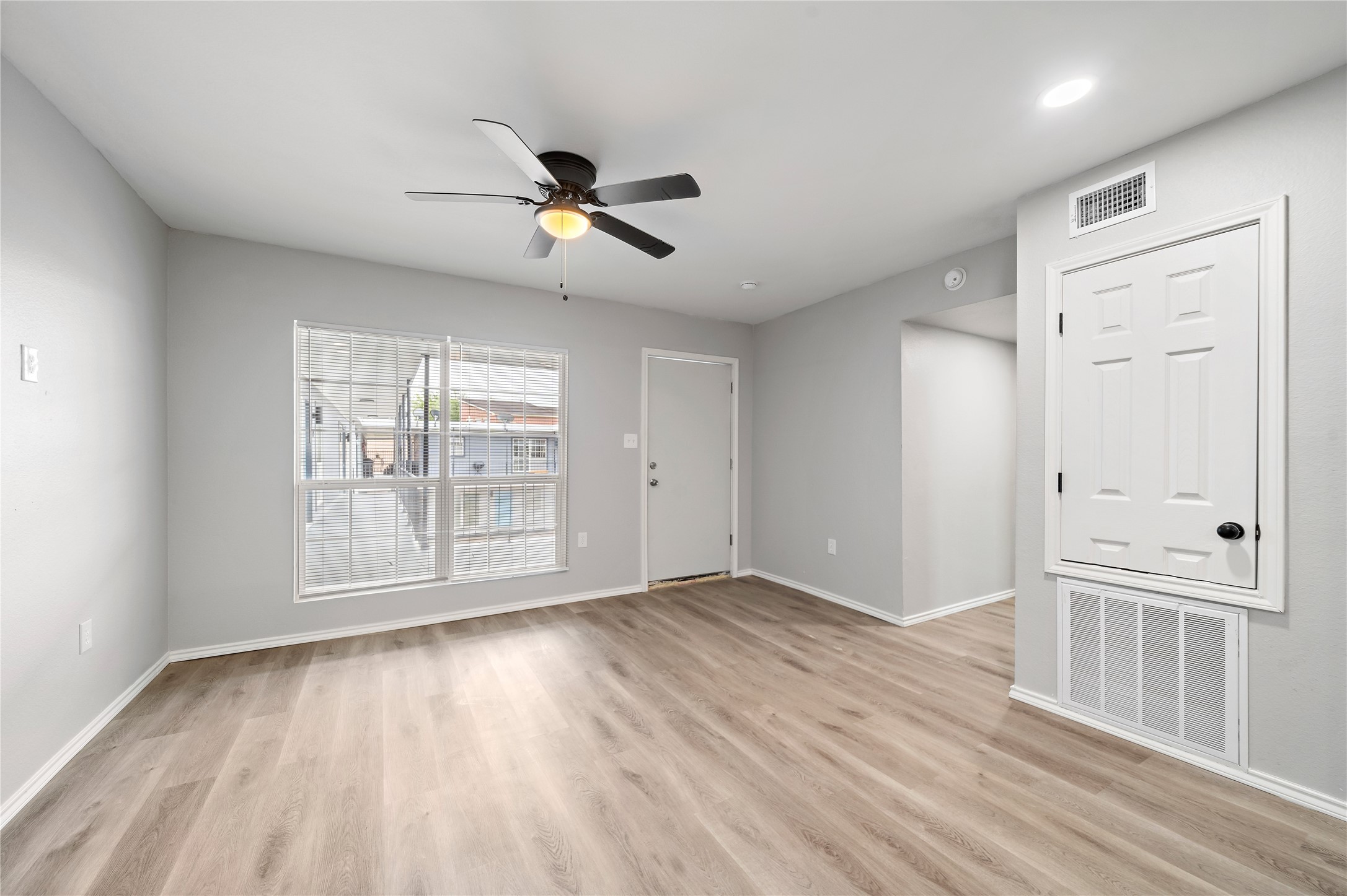 9711 Linkmeadow Lane, Unit 17 Houston, TX 77025 - Photo 7 of 15 a view of an empty room with wooden floor and a window