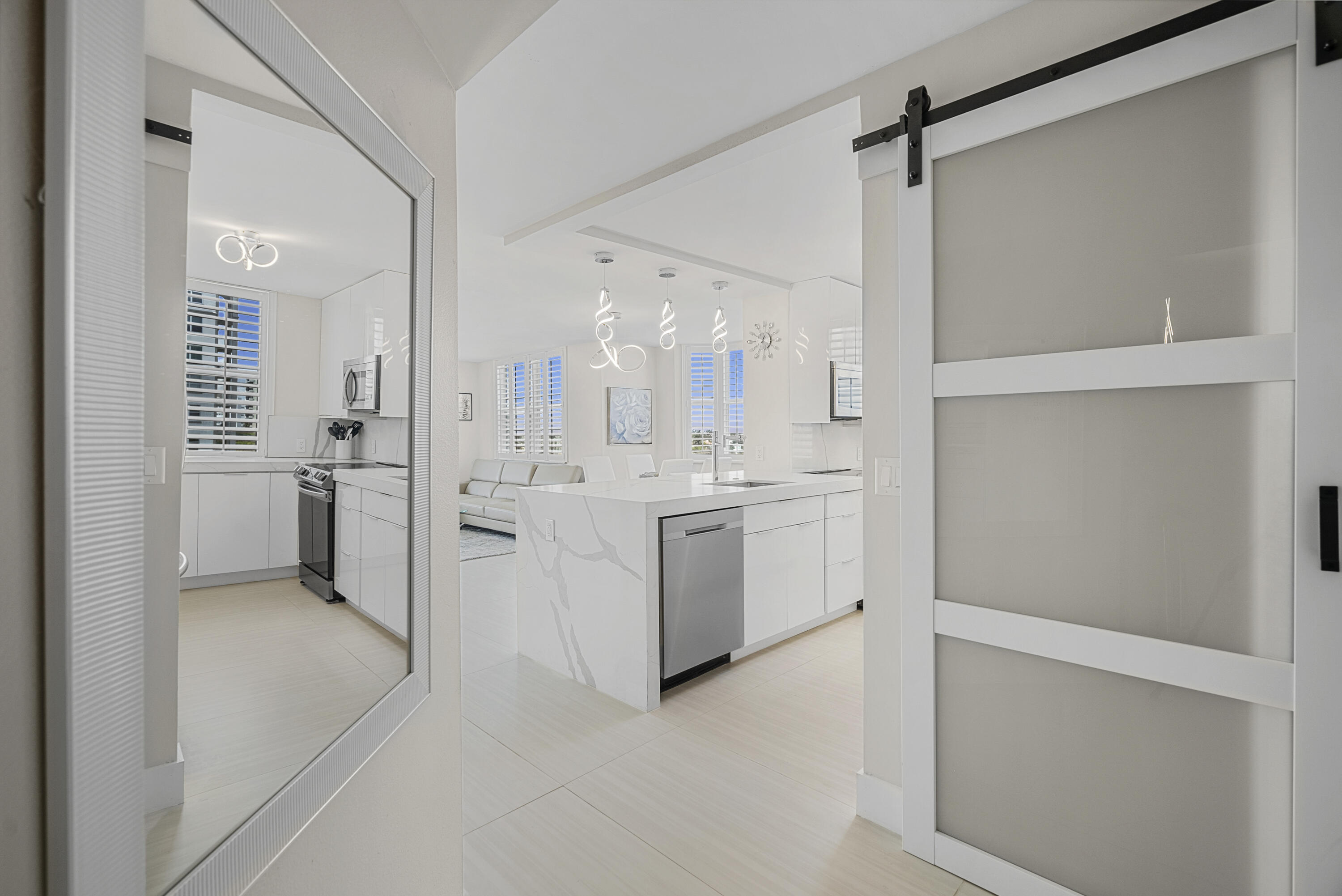 a view of a kitchen with white cabinets