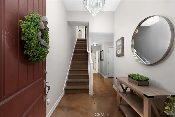 an entryway with a flower pot and a bookshelf