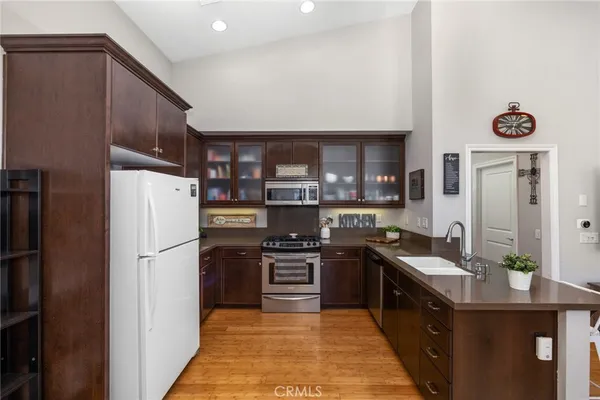 a kitchen with stainless steel appliances granite countertop a refrigerator and a stove