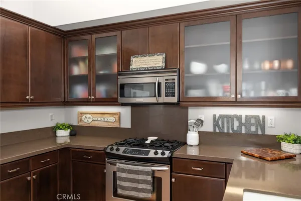 a kitchen with stainless steel appliances granite countertop a stove and a microwave