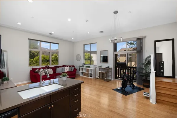 a living room with furniture large window and flat screen tv