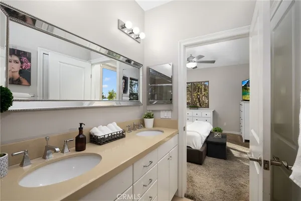 a bathroom with a granite countertop sink mirror and vanity