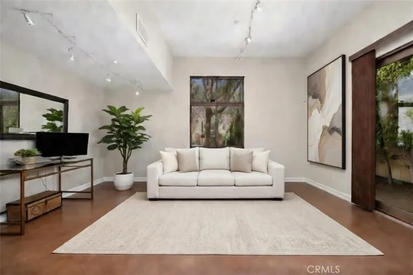 a living room with furniture potted plant and a window