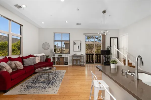 a living room with furniture and wooden floor