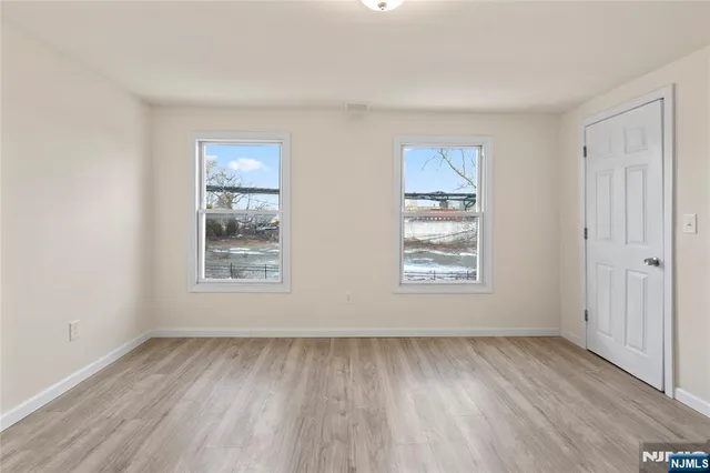 a view of water heater room with refrigerator