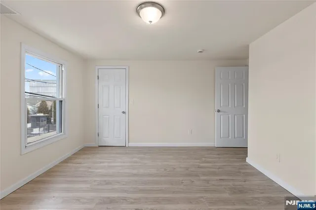 a view of a house with a small yard and wooden fence