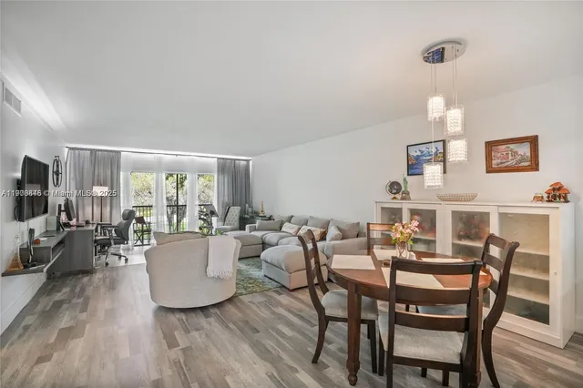 a view of a dining room with furniture and wooden floor