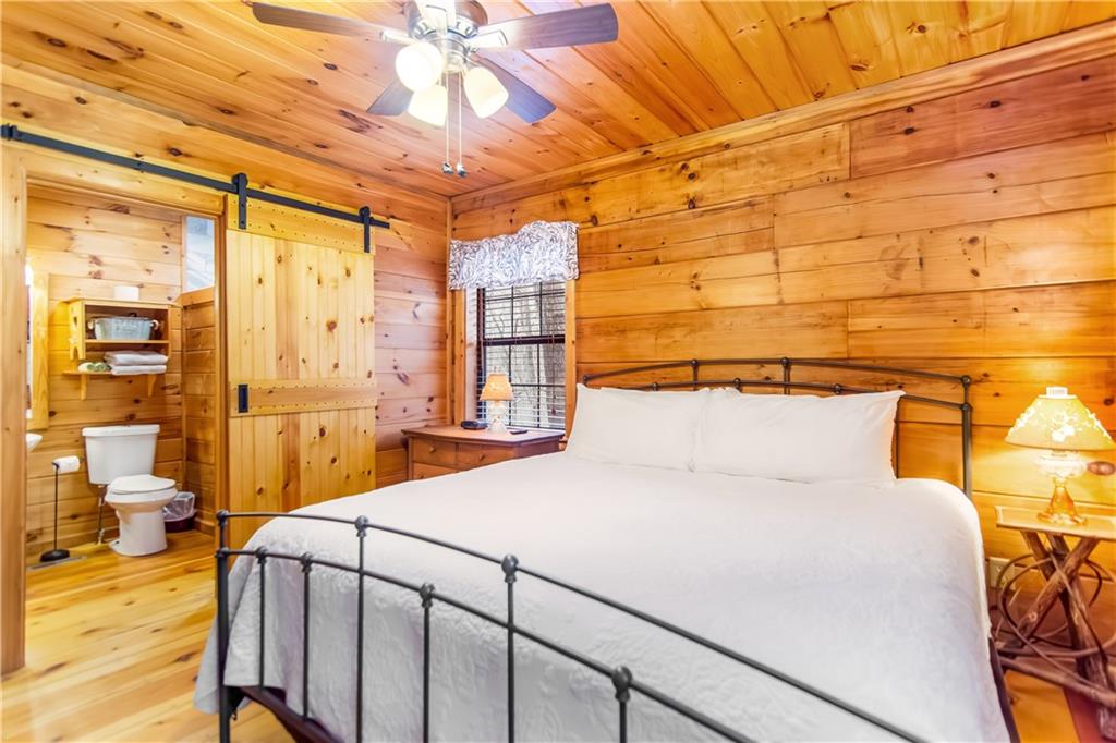 152 Broken Arrow Path Blue Ridge, GA 30513 - Photo 23 of 50 a bedroom with a bed and wooden floor