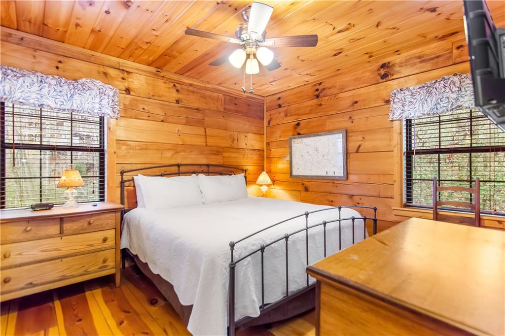 152 Broken Arrow Path Blue Ridge, GA 30513 - Photo 24 of 50 a bedroom with a bed and a large window