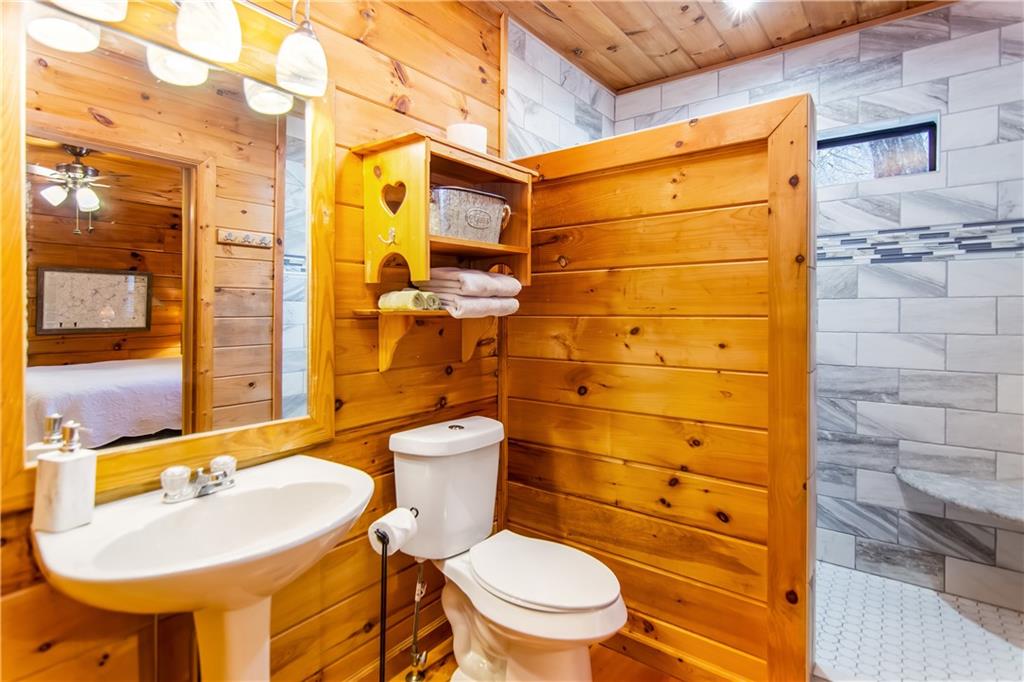 152 Broken Arrow Path Blue Ridge, GA 30513 - Photo 27 of 50 a bathroom with a sink a toilet and shower
