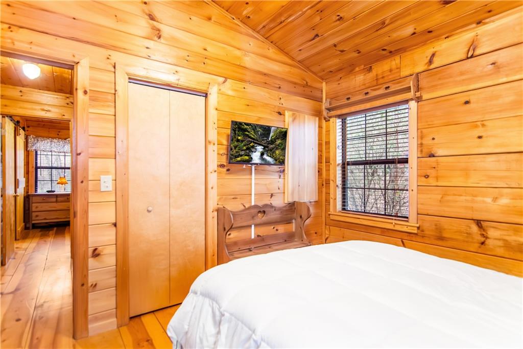 152 Broken Arrow Path Blue Ridge, GA 30513 - Photo 33 of 50 a bedroom with a bed and a large window