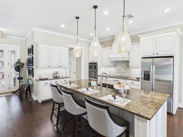 8550 Toler Pointe Larue, TX 75770 - Photo 26 of 37 a kitchen with granite countertop a sink a center island stainless steel appliances and cabinets