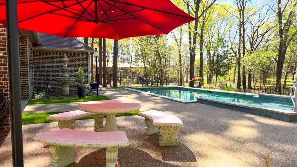 8550 Toler Pointe Larue, TX 75770 - Photo 9 of 37 a view of a patio with table and chairs under an umbrella