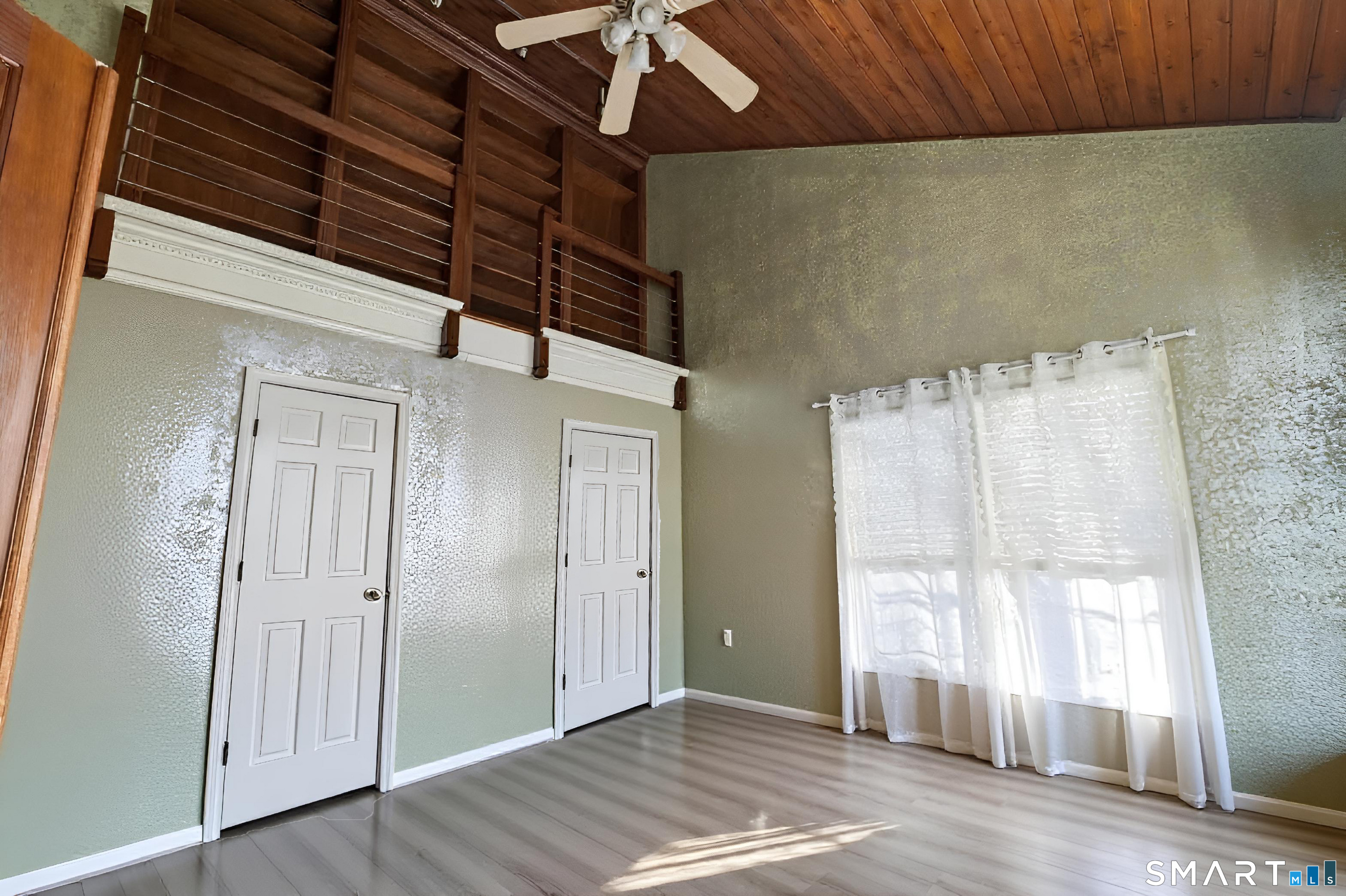 47 Oswegatchie Hills Road East Lyme, CT 06357 - Photo 17 of 40 a view of an empty room with wooden floor and a window