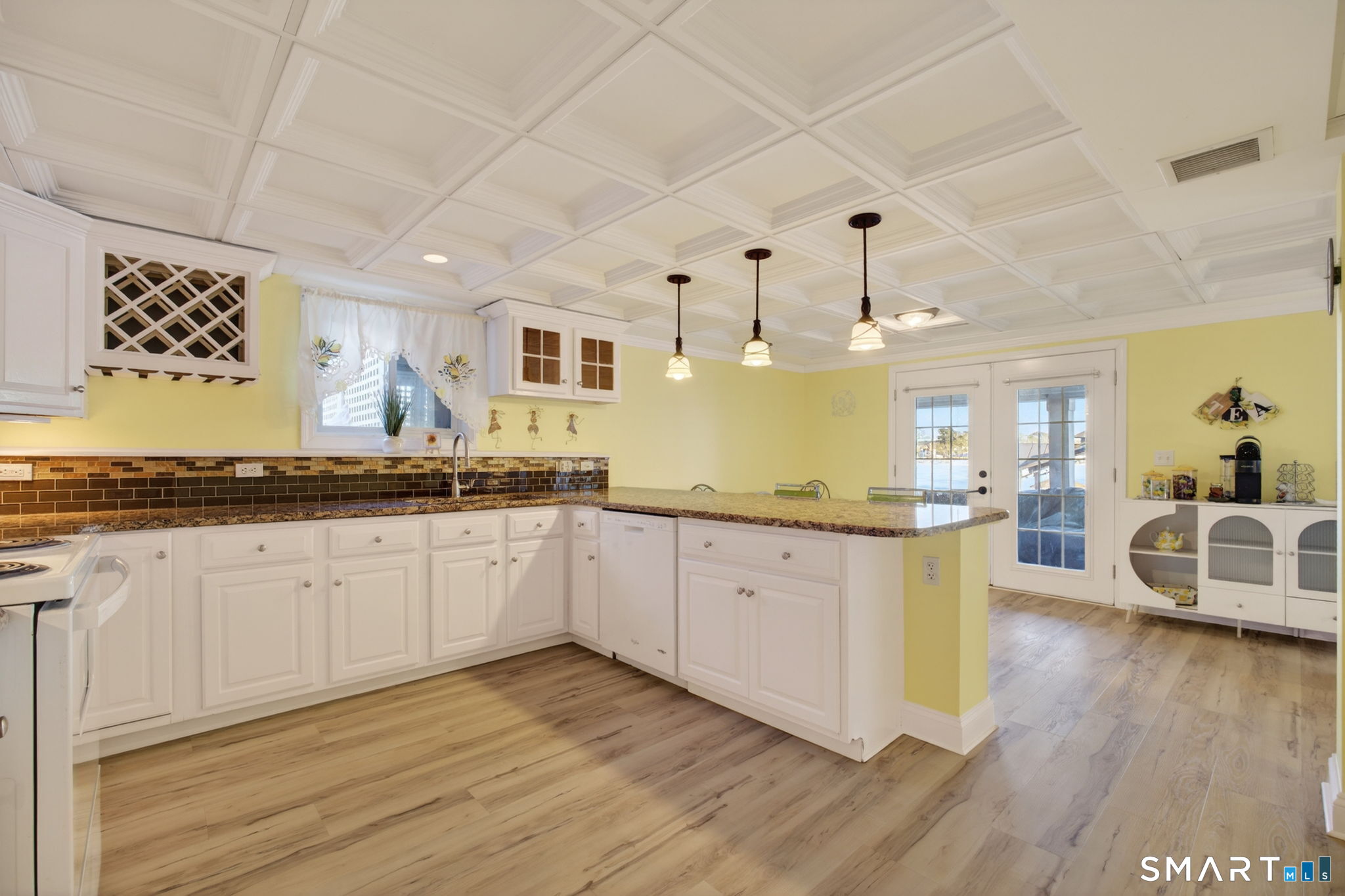 47 Oswegatchie Hills Road East Lyme, CT 06357 - Photo 35 of 40 a kitchen with granite countertop a sink cabinets and wooden floor