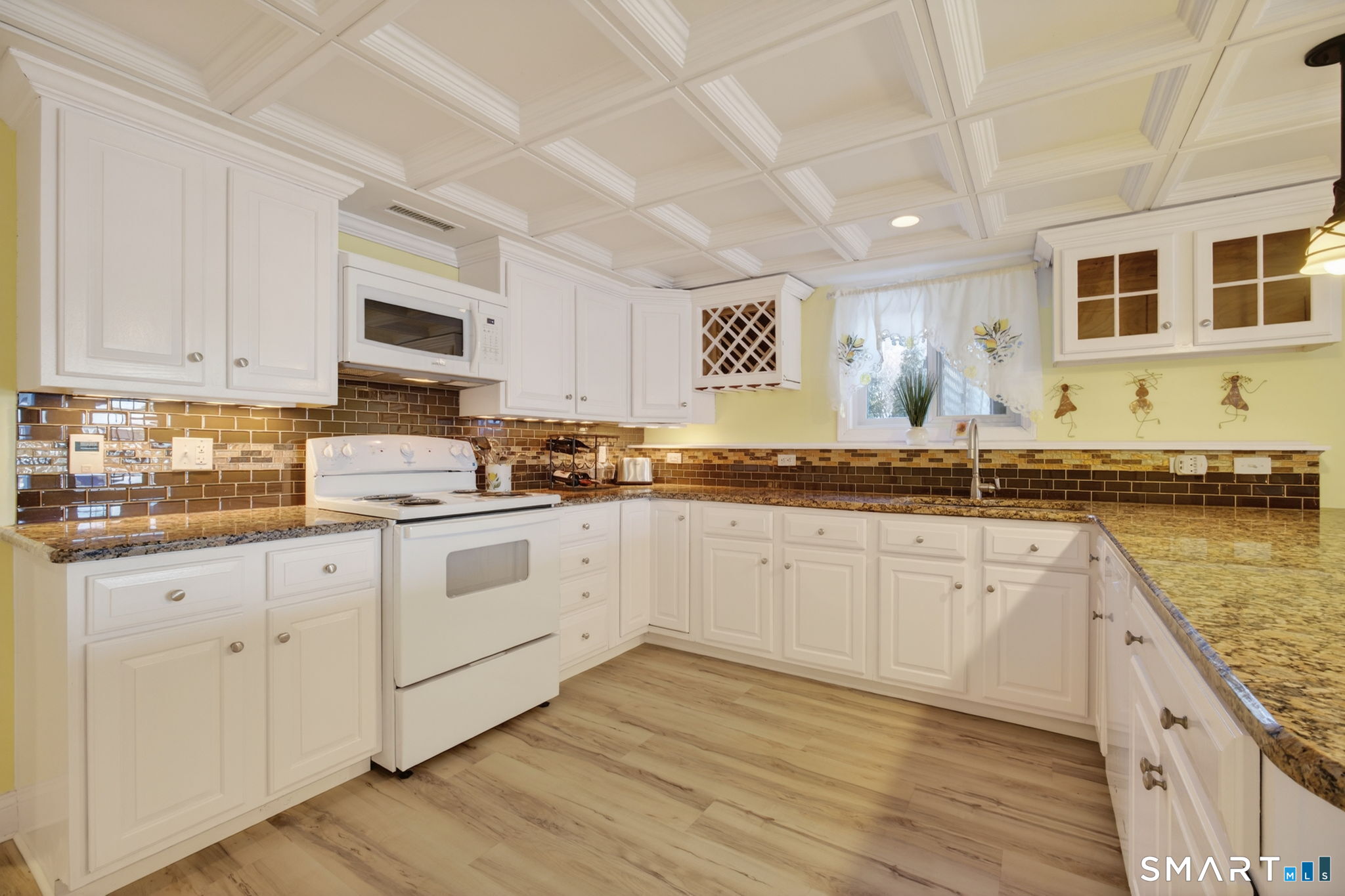 47 Oswegatchie Hills Road East Lyme, CT 06357 - Photo 36 of 40 a kitchen with granite countertop wooden cabinets and white appliances