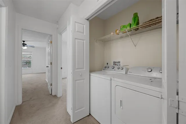 a view of a livingroom with a ceiling fan and window