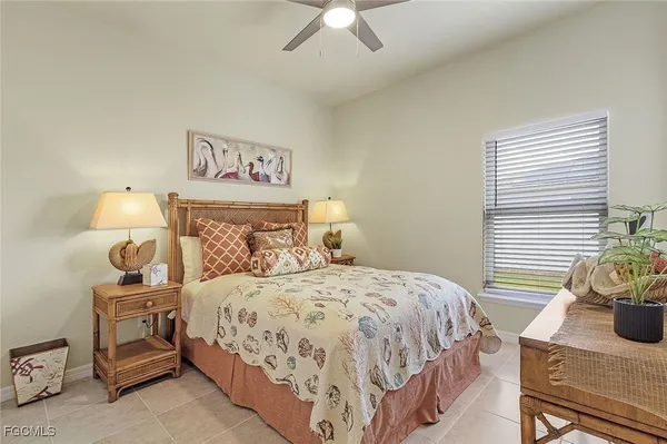 a bedroom with a bed and a potted plant