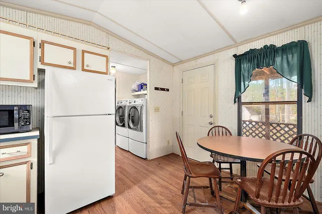 a kitchen with a table and a refrigerator