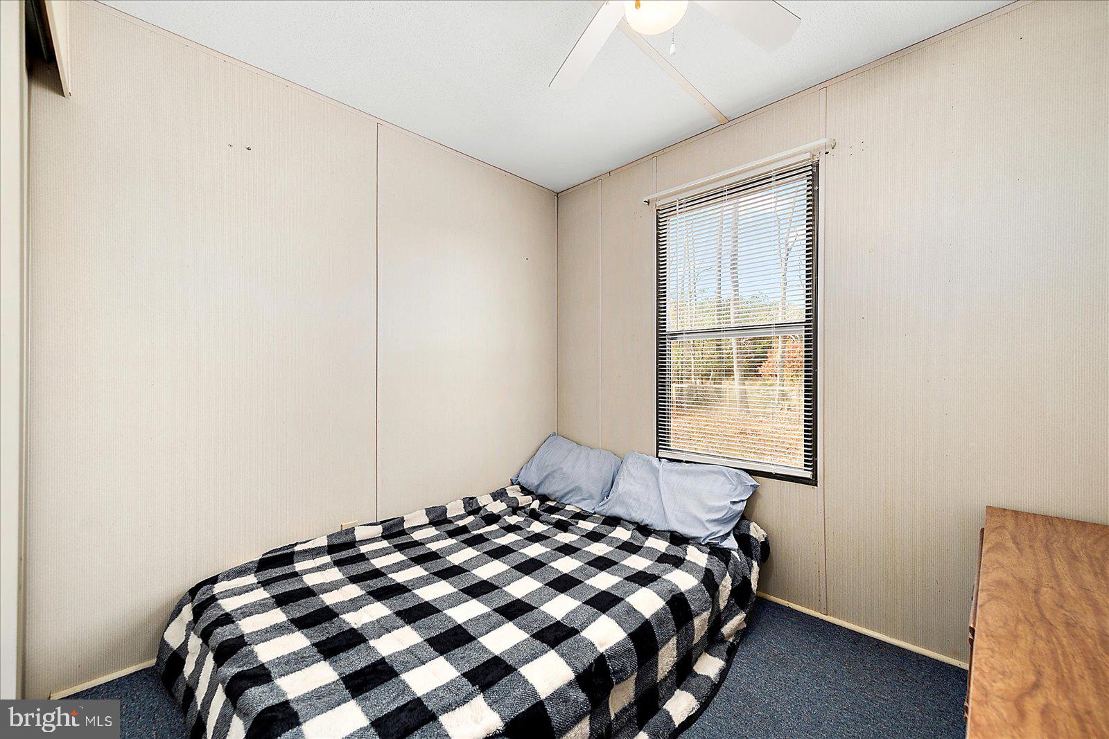 729 Snow Hill Road Stockton, MD 21864 - Photo 14 of 46 a bedroom with a bed and a window