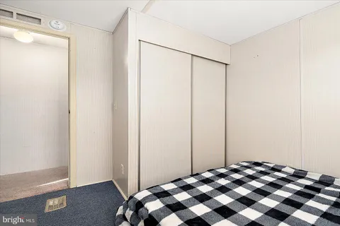 a bedroom with a bed and a mirror