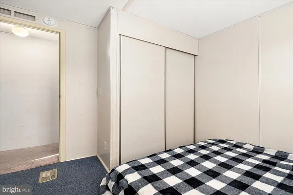 a bedroom with a bed and a mirror