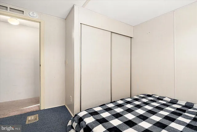 a bedroom with a bed and a mirror