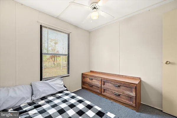 a bedroom with furniture and window
