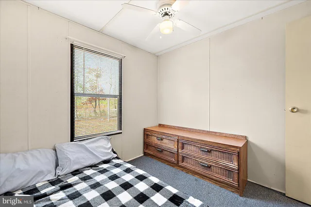 a bedroom with furniture and window