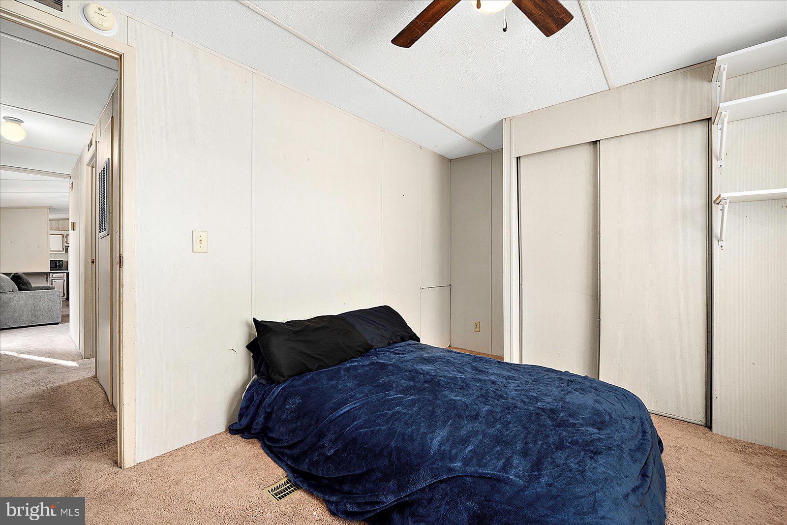 729 Snow Hill Road Stockton, MD 21864 - Photo 23 of 46 a bedroom with a bed and a chandelier