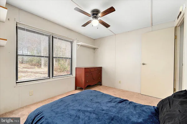 a bedroom with bed and window