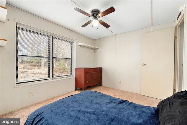 a bedroom with bed and window