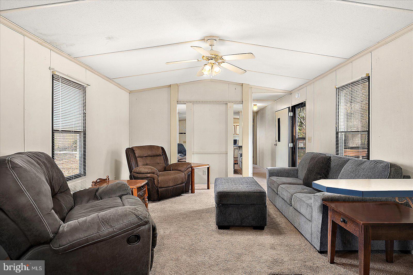 729 Snow Hill Road Stockton, MD 21864 - Photo 3 of 46 a living room with furniture a chandelier and a window