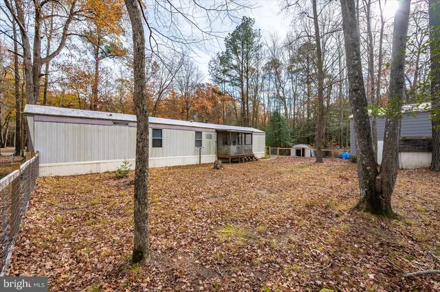 a view of a house with a yard covered in snow