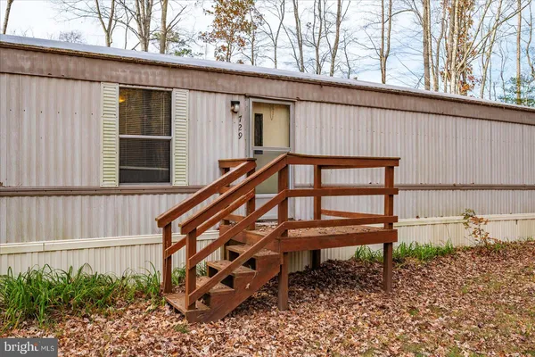 a wooden bench sitting in front of a building