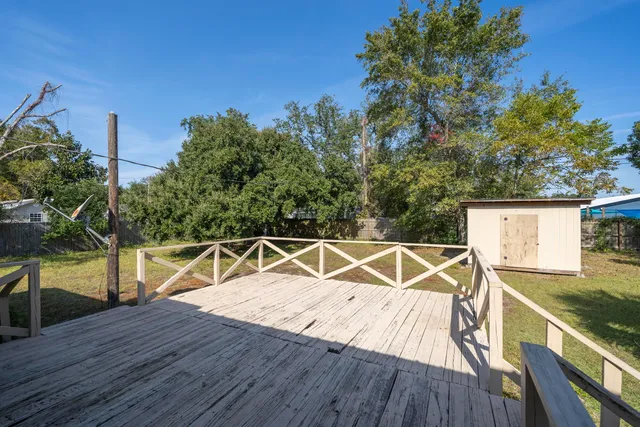 a view of a roof deck with wooden floor and fence