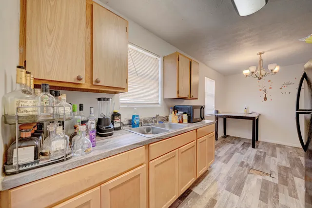 a kitchen with stainless steel appliances granite countertop a sink a stove and cabinets