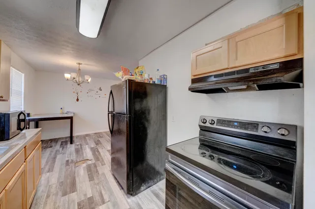 a kitchen with stainless steel appliances a refrigerator a stove and a sink