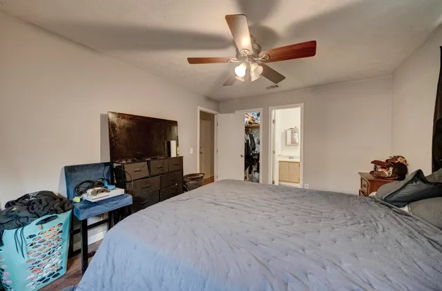 a bedroom with a bed and a flat screen tv