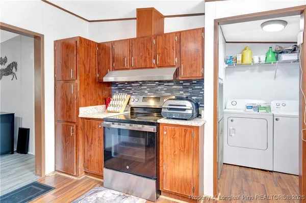 a kitchen with stainless steel appliances granite countertop a stove and a refrigerator