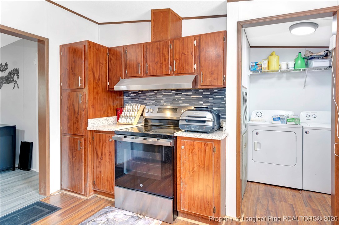 155 Willard Tatum Road Elizabethtown, NC 28337 - Photo 11 of 23 a kitchen with stainless steel appliances granite countertop a stove and a refrigerator