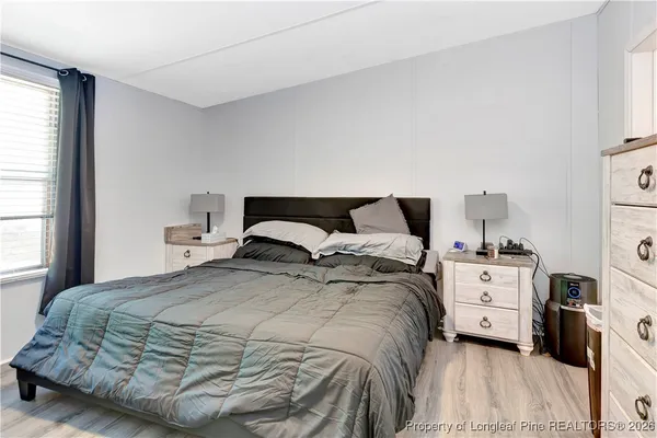 a bedroom with a bed and a large window