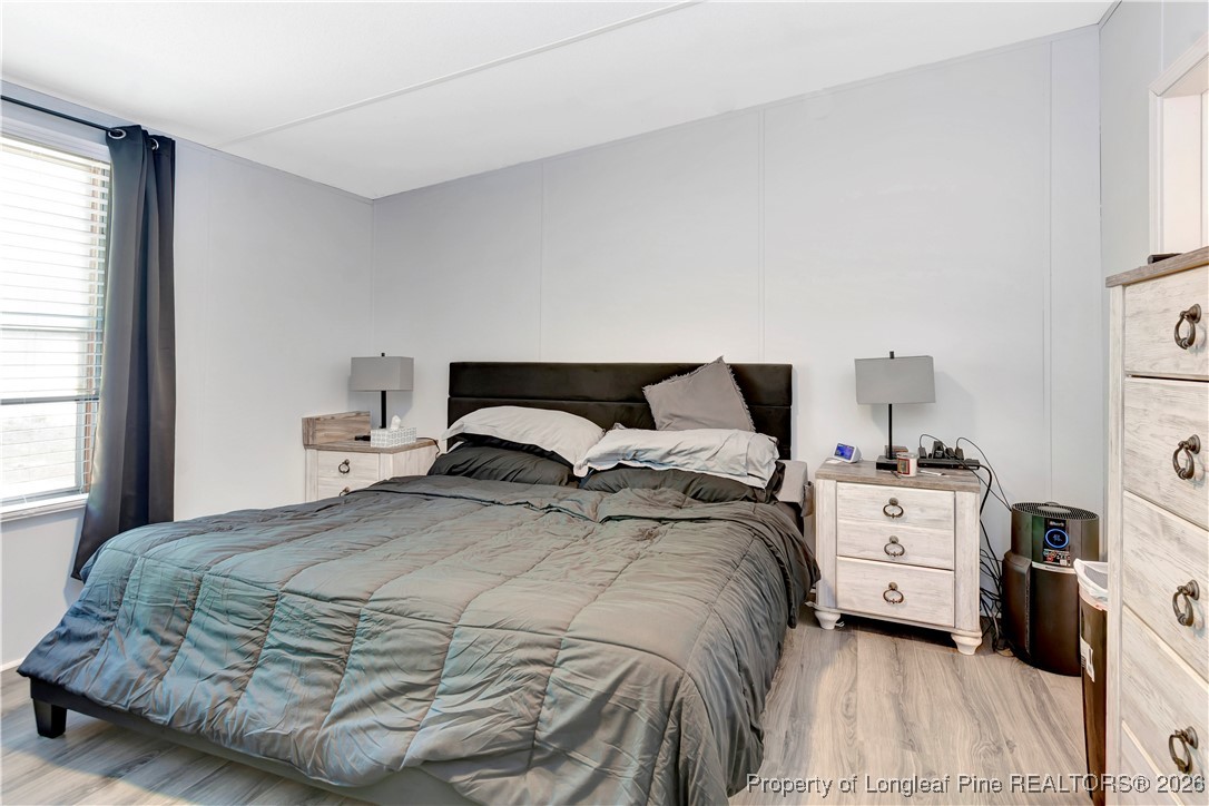 155 Willard Tatum Road Elizabethtown, NC 28337 - Photo 12 of 23 a bedroom with a bed and a large window