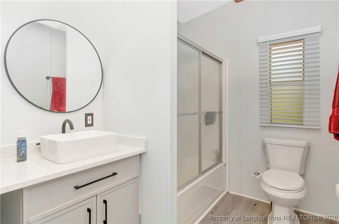 155 Willard Tatum Road Elizabethtown, NC 28337 - Photo 20 of 23 a bathroom with a sink a toilet and a mirror