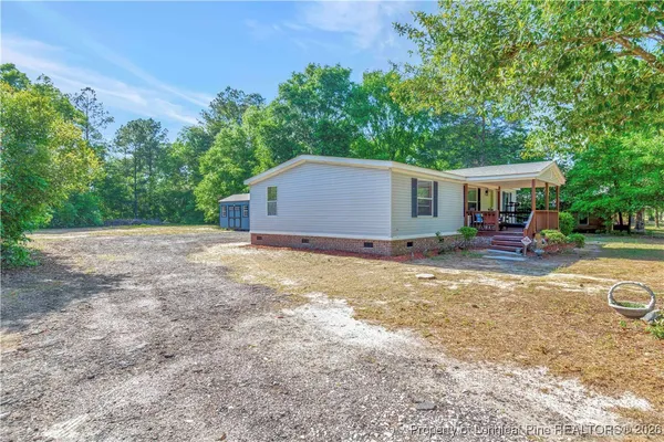 a backyard of a house with yard and outdoor seating