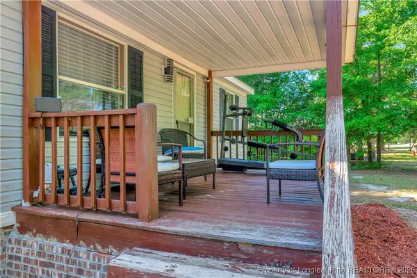 a view of a patio with a table chairs and a porch