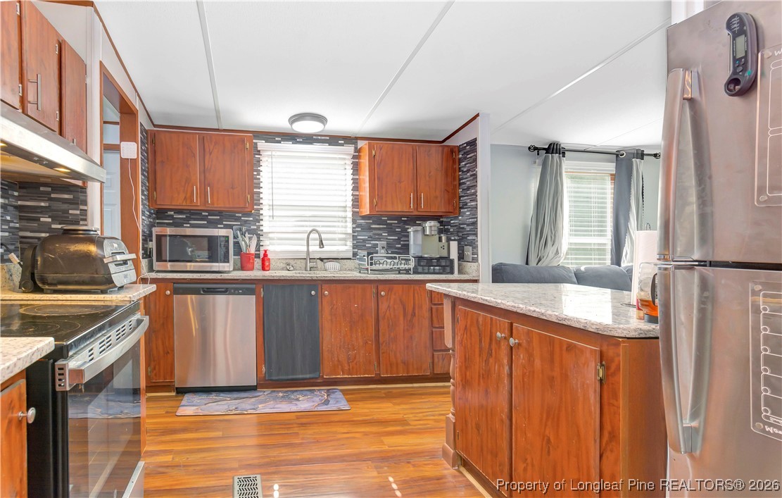 155 Willard Tatum Road Elizabethtown, NC 28337 - Photo 10 of 23 a kitchen with stainless steel appliances granite countertop a sink stove and refrigerator